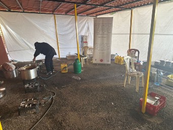 The makeshift kitchen has been set up outside a school housing displaced families.