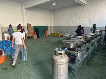 We moved our makeshift kitchen to a more permanent structure within the school housing the displaced families