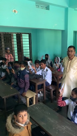Our fundraised money being given to the poorest students of the school.