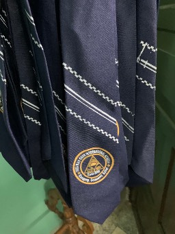 My grandfather’s name on the school uniform’s ties. May Allah help us continue his legacy.